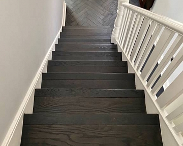 Anthracite oak stair cladding and herringbone floors in London